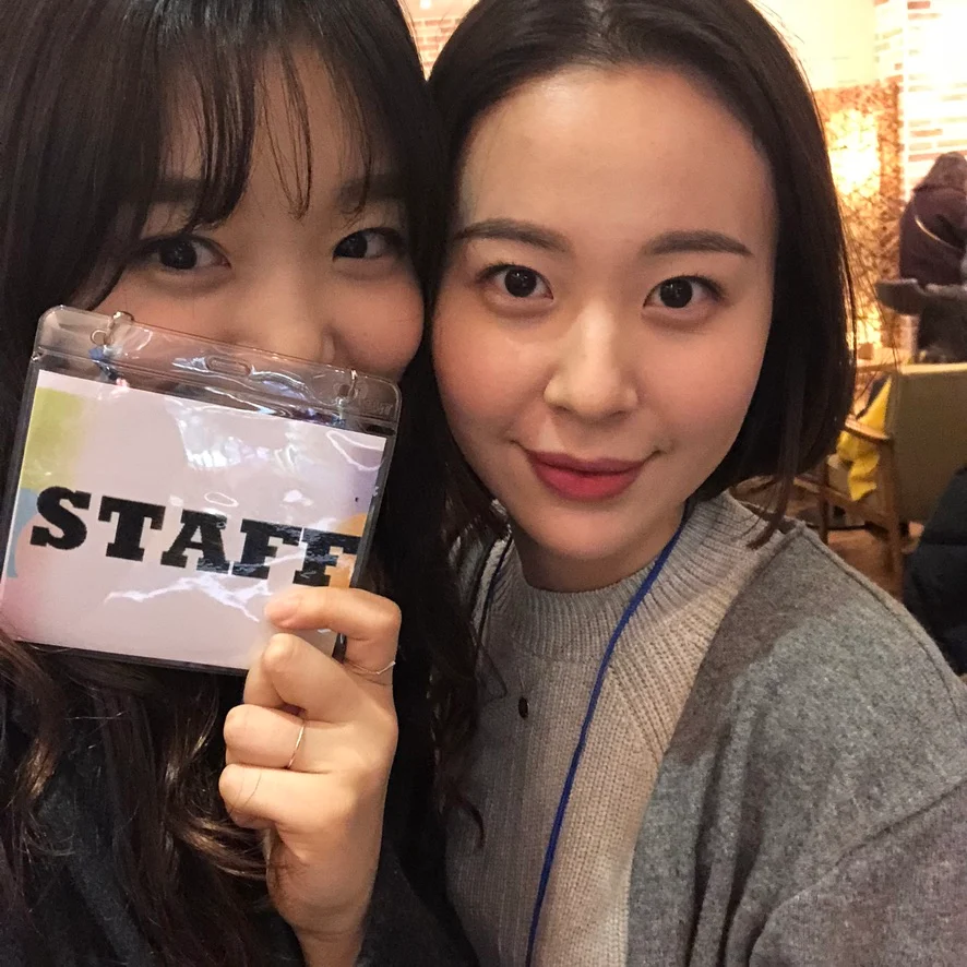 A close-up staff photograph with a staff pass