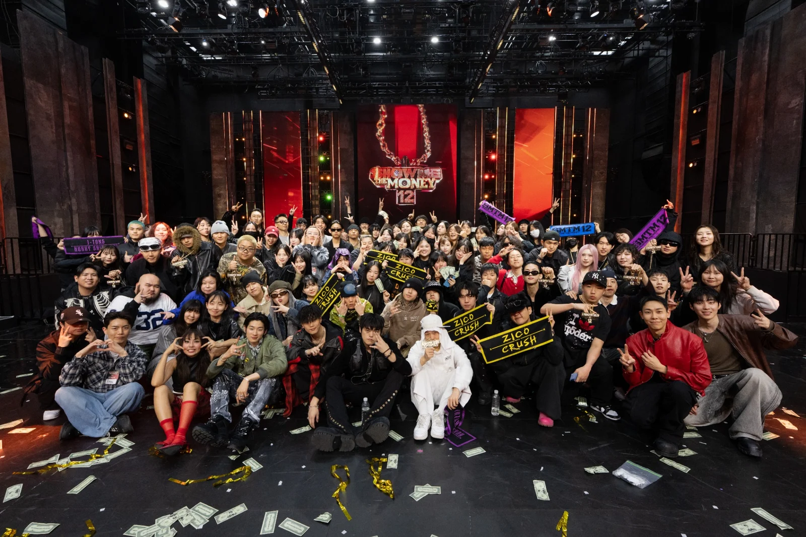 A large group on a music program stage