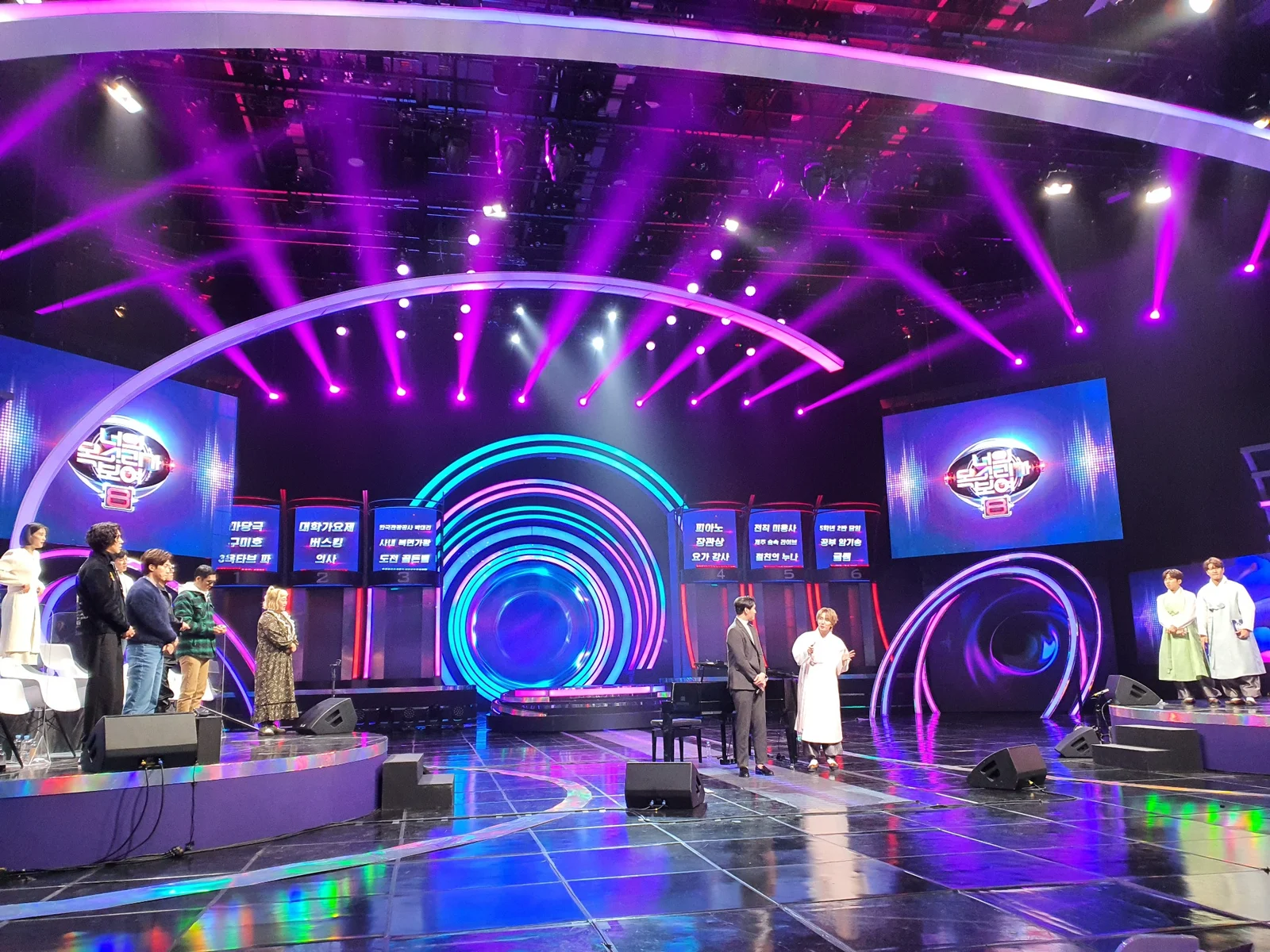 A brightly lit television studio stage during filming