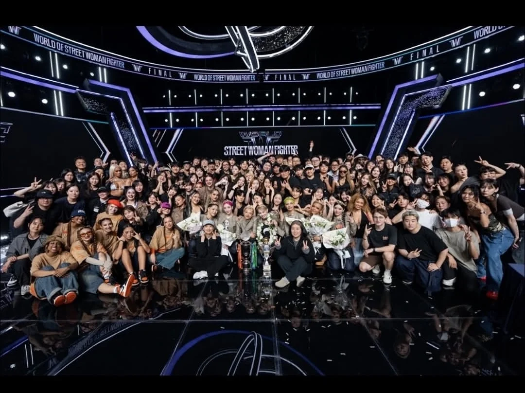 A large group on a dance program stage