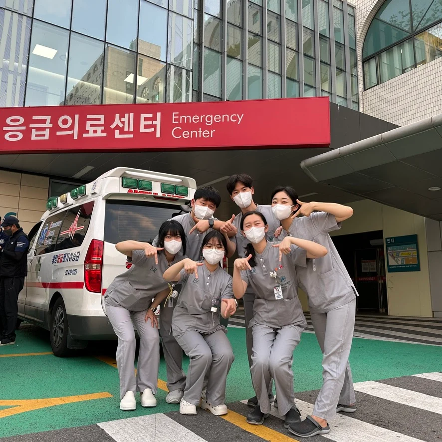 Colleagues in scrubs outside the emergency center