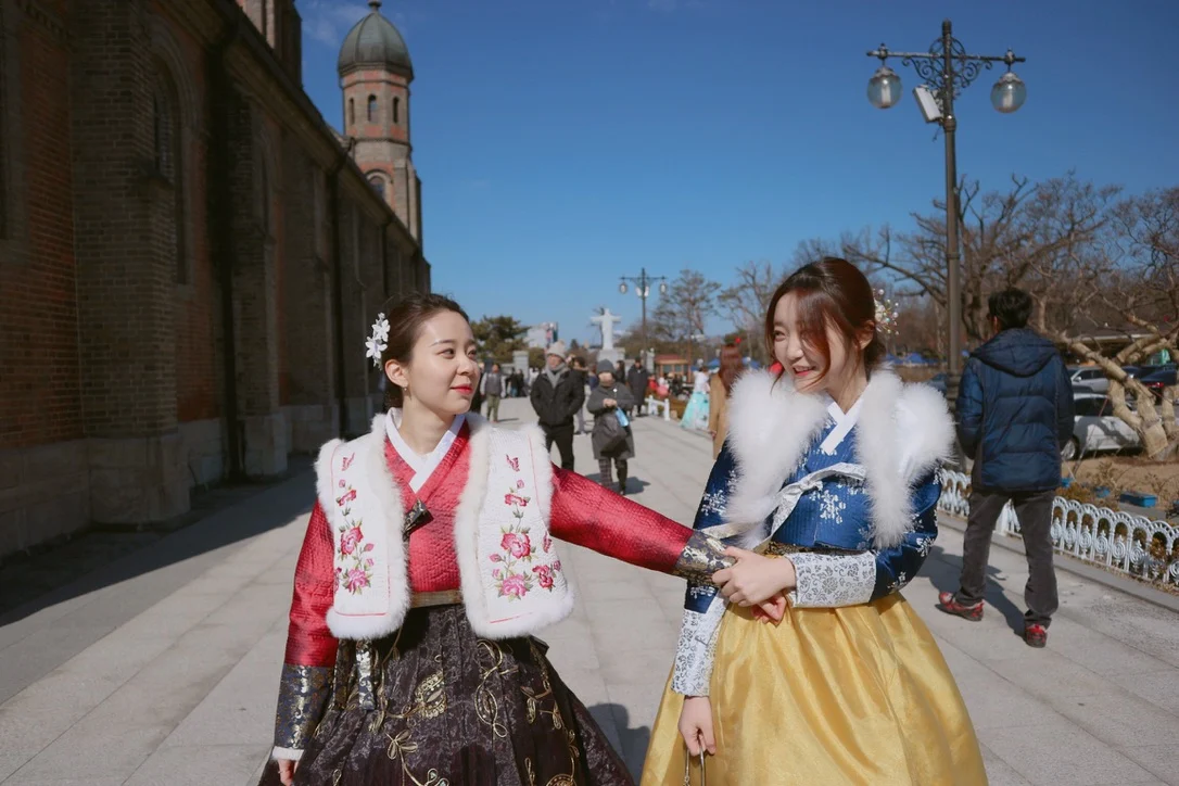 Two models in winter hanbok walking together