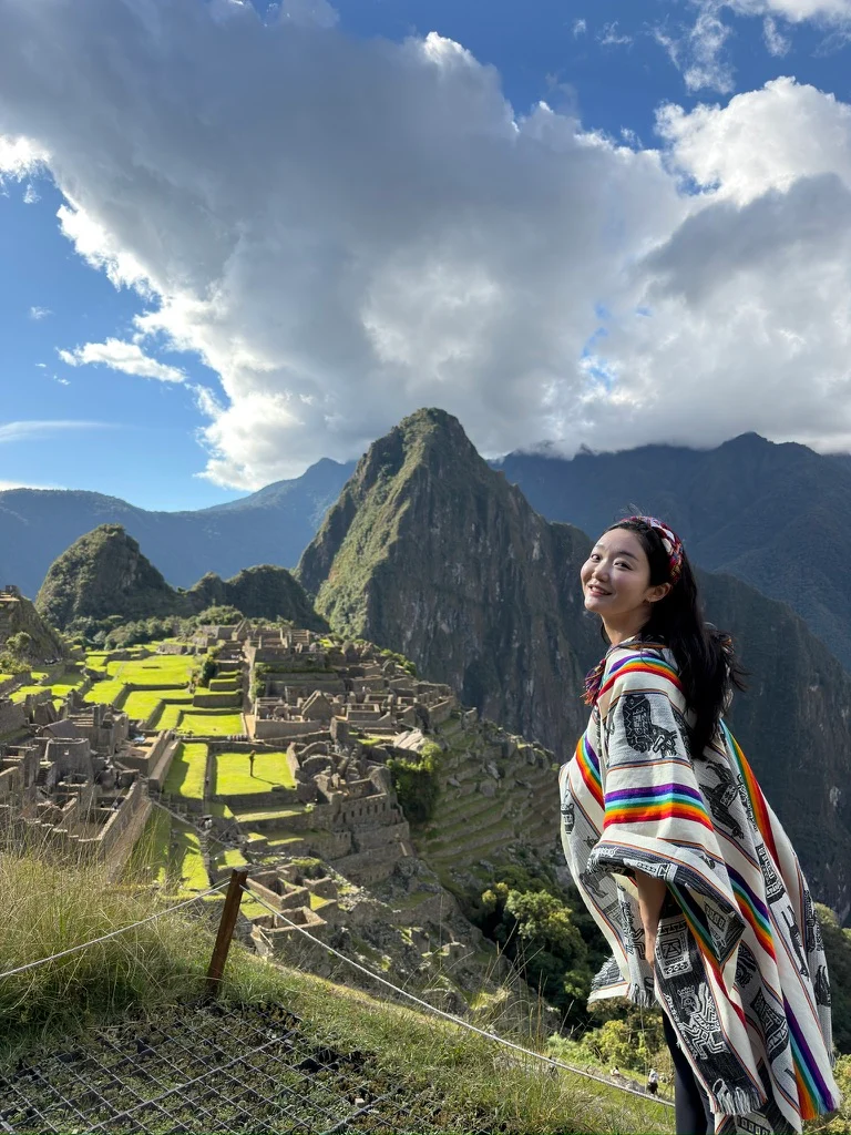 A traveler overlooking mountain ruins