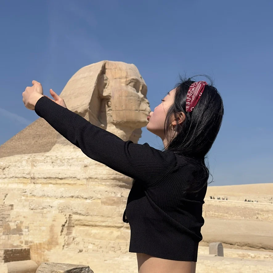 A playful travel photograph beside the Sphinx
