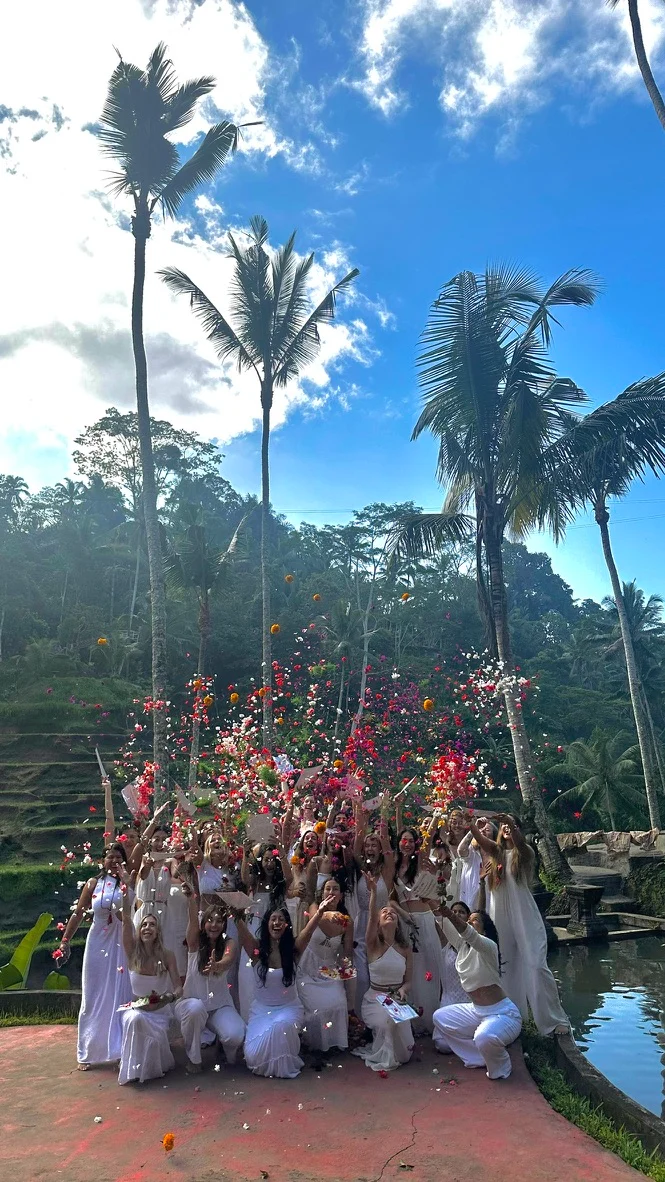 A group throwing flower petals into the air